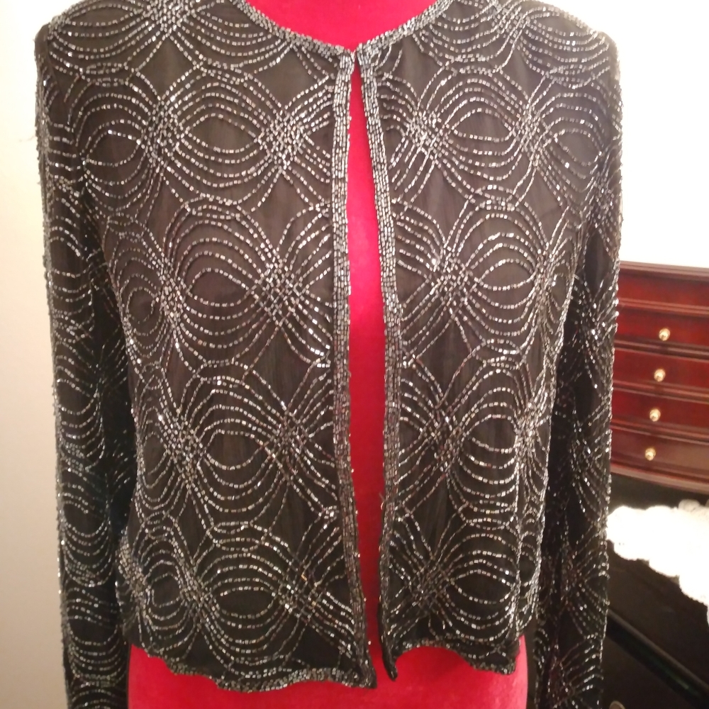 Like new.  Silk and beaded jacket